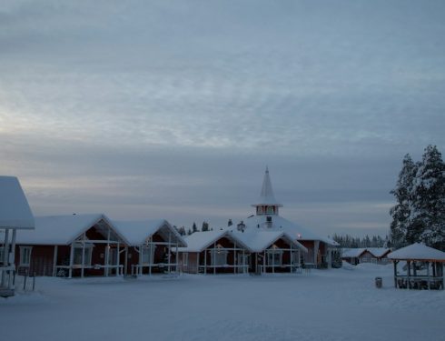 a small church in the middle of a snowy field